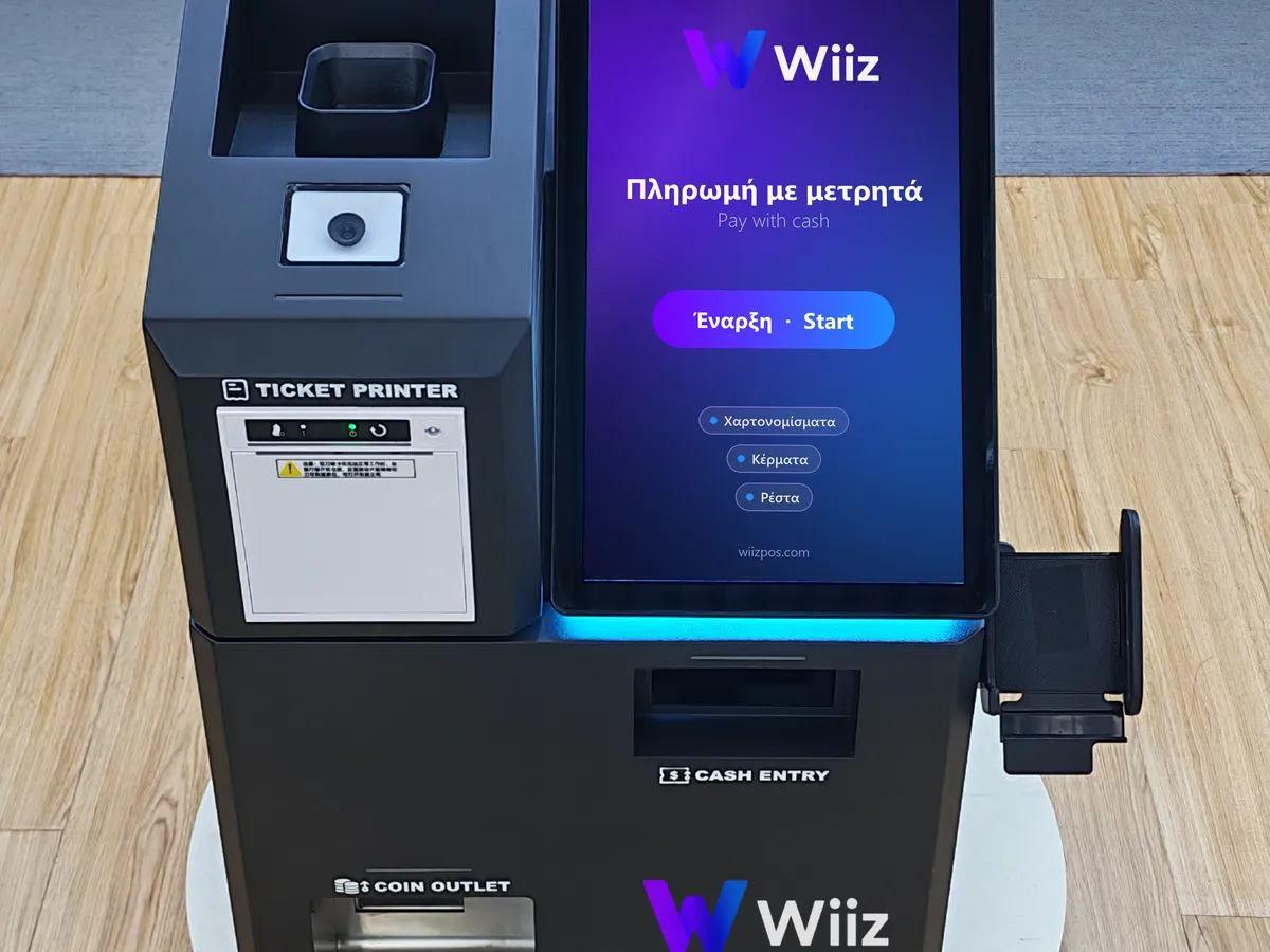 Αυτόματο ταμείο μετρητών Wiiz με οθόνη αφής, υποδοχή για χαρτονομίσματα και έξοδο κερμάτων για τα ρέστα